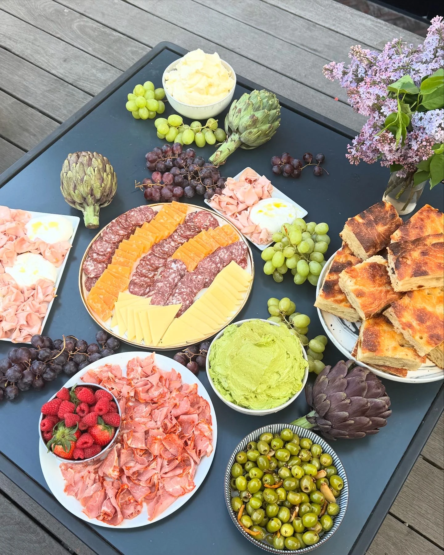 A generous Primo spread of charcuterie, cheeses, fruit, dips, and focaccia